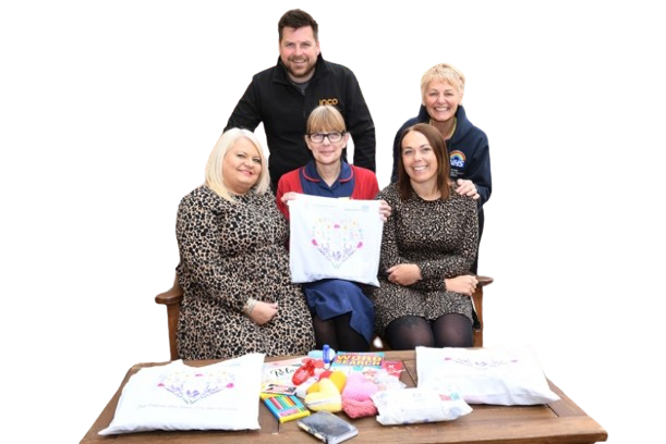 Five people in front of charity stand